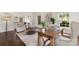 Open-concept living room with hardwood floors and large windows letting in natural light at 7213 Lancer Dr, Charlotte, NC 28226