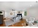 Spacious main bedroom with hardwood floors, ceiling fan, and large windows for natural light at 7213 Lancer Dr, Charlotte, NC 28226