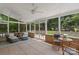 Relax on this screened porch with ceiling fans and views of the landscaped backyard at 7213 Lancer Dr, Charlotte, NC 28226