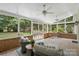 Relax on this screened porch with ceiling fans and views of the landscaped backyard at 7213 Lancer Dr, Charlotte, NC 28226