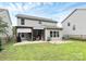 Spacious backyard with a covered patio, outdoor furniture, and well-maintained lawn at 7434 Dover Mill Sw Ln, Concord, NC 28025
