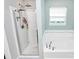 Modern bathroom featuring a glass-enclosed shower, a soaking tub, and white tile accents at 7434 Dover Mill Sw Ln, Concord, NC 28025