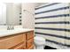 Bathroom featuring a single sink vanity, toilet, and shower with striped curtain at 7434 Dover Mill Sw Ln, Concord, NC 28025