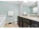 Well-lit bathroom features a double sink vanity with granite countertops, a large mirror, and neutral wall color at 7434 Dover Mill Sw Ln, Concord, NC 28025