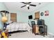 A cozy bedroom features natural light, a ceiling fan, and decor details at 7434 Dover Mill Sw Ln, Concord, NC 28025