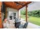 Inviting covered patio with wooden ceiling, outdoor seating, and a view of the fenced backyard at 7434 Dover Mill Sw Ln, Concord, NC 28025