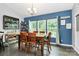 Inviting dining area features a classic table set, natural light from large windows, and charming decor creates a warm ambiance at 7434 Dover Mill Sw Ln, Concord, NC 28025
