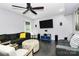 Spacious living room boasts a ceiling fan, dark hardwood floors, and comfortable seating for relaxation and entertainment at 7434 Dover Mill Sw Ln, Concord, NC 28025