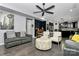 Open living room with hardwood floors, a ceiling fan, and an open kitchen in the background at 7434 Dover Mill Sw Ln, Concord, NC 28025