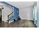 Bright and airy living room boasts hardwood floors, staircase, and natural light, ready for your personal touch at 7434 Dover Mill Sw Ln, Concord, NC 28025
