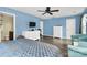 Expansive main bedroom with light blue walls, ceiling fan, dresser and plenty of closet space at 7434 Dover Mill Sw Ln, Concord, NC 28025