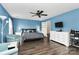 Stylish main bedroom with a ceiling fan, light blue walls, and modern furnishings including a large bed and dresser at 7434 Dover Mill Sw Ln, Concord, NC 28025