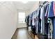 Spacious walk-in closet with wood floor and metal shelving for optimal storage, and natural light from the single window at 7434 Dover Mill Sw Ln, Concord, NC 28025