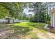 A large grassy backyard features a storage shed and is enclosed by a white picket fence at 747 Saint Michaels Ln # 7, Gastonia, NC 28052