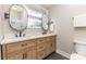 Bathroom boasts dual sinks with a wooden cabinet and black accents, complemented by stylish mirrors and fixtures at 747 Saint Michaels Ln # 7, Gastonia, NC 28052