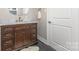 Stylish bathroom with dark wood vanity, marble countertop, gold fixtures and a large white door at 747 Saint Michaels Ln # 7, Gastonia, NC 28052