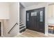 The foyer features hardwood flooring, a black front door and a staircase at 747 Saint Michaels Ln # 7, Gastonia, NC 28052