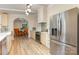Bright kitchen with stainless steel refrigerator, tile backsplash, and natural light at 747 Saint Michaels Ln # 7, Gastonia, NC 28052