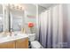 A cozy bathroom featuring a modern vanity, a toilet, and white and gray decor at 7881 Mariners Pointe Cir, Denver, NC 28037