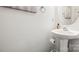Clean half bathroom with a modern pedestal sink and neutral decor at 7881 Mariners Pointe Cir, Denver, NC 28037