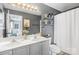 A well-lit bathroom with a double sink vanity, modern fixtures, and neutral gray walls at 7881 Mariners Pointe Cir, Denver, NC 28037