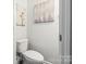 Well-kept half bathroom featuring standard toilet and modern décor at 7881 Mariners Pointe Cir, Denver, NC 28037