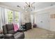 A cute Bedroom featuring a decorative floral wall, a crib, and a modern chandelier at 7881 Mariners Pointe Cir, Denver, NC 28037