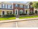 Charming townhome featuring a brick facade, blue shutters, and well-manicured landscaping, creating inviting curb appeal at 7881 Mariners Pointe Cir, Denver, NC 28037