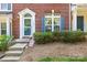 Welcoming brick townhome with blue shutters, and meticulously maintained landscaping at 7881 Mariners Pointe Cir, Denver, NC 28037