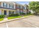 Inviting townhome showcasing brick and siding exterior, blue shutters, and manicured lawn at 7881 Mariners Pointe Cir, Denver, NC 28037
