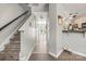 Inviting hallway and staircase lead to the home's entry and kitchen at 7881 Mariners Pointe Cir, Denver, NC 28037