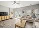Relaxing living room with modern furnishings, complemented by natural light and elegant flooring at 7881 Mariners Pointe Cir, Denver, NC 28037