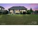 Picturesque backyard featuring a patio, gazebo, well-maintained lawn, and lush greenery at 8340 Breton Way, Harrisburg, NC 28075