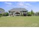 Spacious backyard featuring a patio, gazebo, lush lawn, and mature landscaping at 8340 Breton Way, Harrisburg, NC 28075