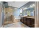 Spacious bathroom with a glass shower, soaking tub, double sink vanity, and modern fixtures at 8340 Breton Way, Harrisburg, NC 28075