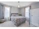 Bright bedroom with neutral tones, patterned bedding, and sheer curtains for a relaxing atmosphere at 8340 Breton Way, Harrisburg, NC 28075