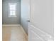 Cozy bedroom with neutral paint, tiled floors, and natural light from the window at 8340 Breton Way, Harrisburg, NC 28075