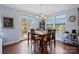 Dining room with a view of the backyard, hardwood floors, and natural light at 8340 Breton Way, Harrisburg, NC 28075