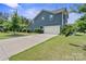 Long driveway leading to a two-car garage and backyard basketball hoop, surrounded by well-maintained lawn at 8340 Breton Way, Harrisburg, NC 28075