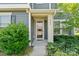 Close-up of the house entrance featuring well-kept landscaping and an inviting front porch at 8340 Breton Way, Harrisburg, NC 28075