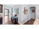 Inviting hallway adorned with tasteful artwork and dark hardwood floors, leading to other rooms in the home at 8340 Breton Way, Harrisburg, NC 28075