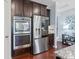 Kitchen with stainless steel appliances, dark cabinets, tile backsplash, and an oven at 8340 Breton Way, Harrisburg, NC 28075