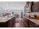 Well-equipped kitchen with granite countertops, stainless steel appliances, and dark hardwood floors with island seating at 8340 Breton Way, Harrisburg, NC 28075