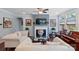 Bright living room features a fireplace, natural light, hardwood floors, and neutral colored walls at 8340 Breton Way, Harrisburg, NC 28075