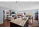 Open concept living room with a large island, hardwood floors, fireplace, and lots of natural light at 8340 Breton Way, Harrisburg, NC 28075