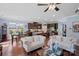 Open concept living room with an island, dining room, fireplace, and hardwood floors at 8340 Breton Way, Harrisburg, NC 28075