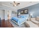 Inviting main bedroom featuring hardwood floors, a sitting area, natural light, and an ensuite bath at 8340 Breton Way, Harrisburg, NC 28075