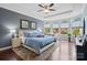 Bright main bedroom with a plush rug, hardwood floors, sitting area, and plenty of natural light at 8340 Breton Way, Harrisburg, NC 28075