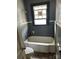 Bathroom area showcasing a vintage tub and window, poised for renovation and customization at 839 S Chester St, Gastonia, NC 28052