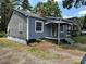 A cozy home with blue siding and white trim, featuring a covered porch and visible wear at 839 S Chester St, Gastonia, NC 28052